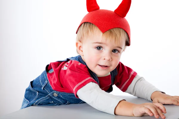 A funny boy in a hat with horns — Stock Photo, Image
