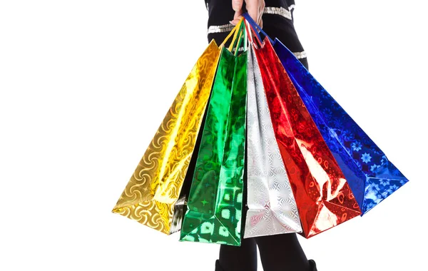 Uma mulher em botas altas com sacos de papel brilhante — Fotografia de Stock