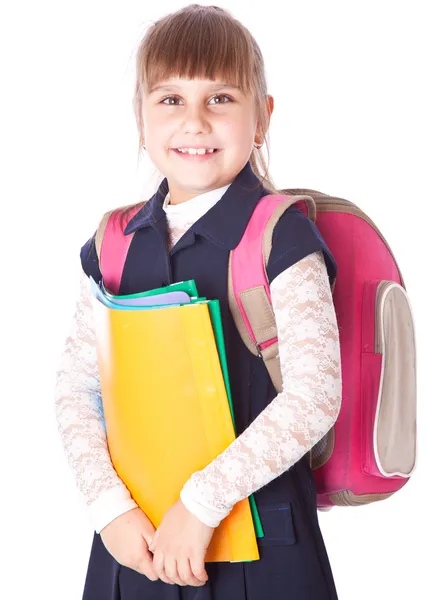 Uma menina em uma mochila está segurando pastas nas mãos — Fotografia de Stock