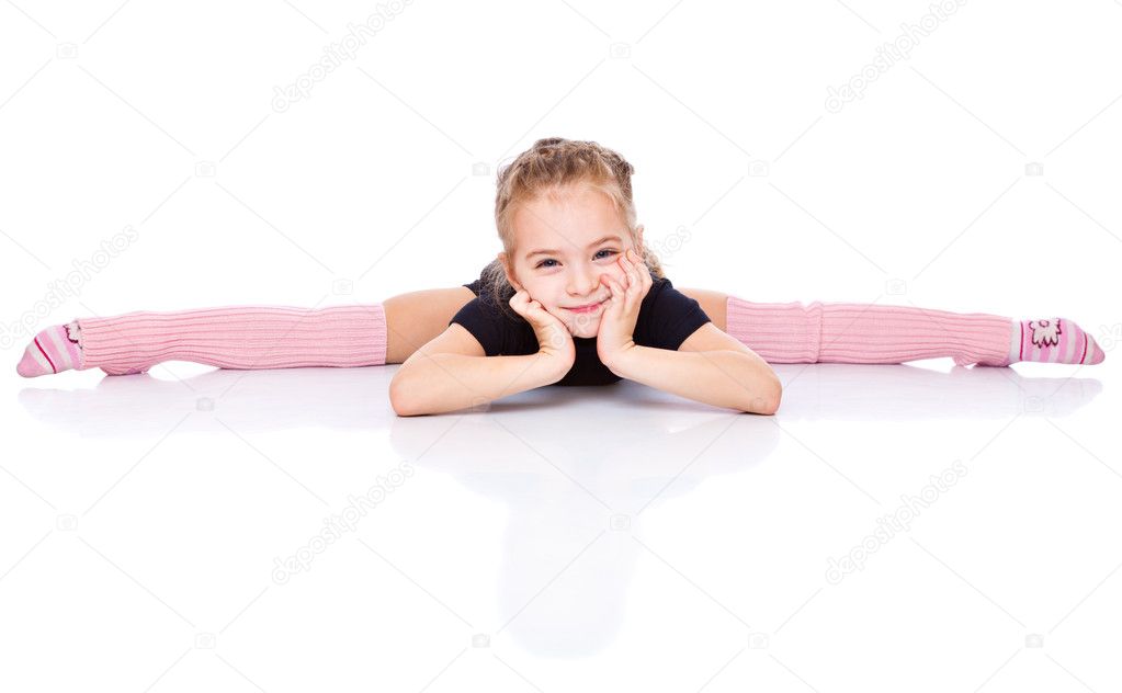 A beautiful girl sits on a splits. isolated on a white background