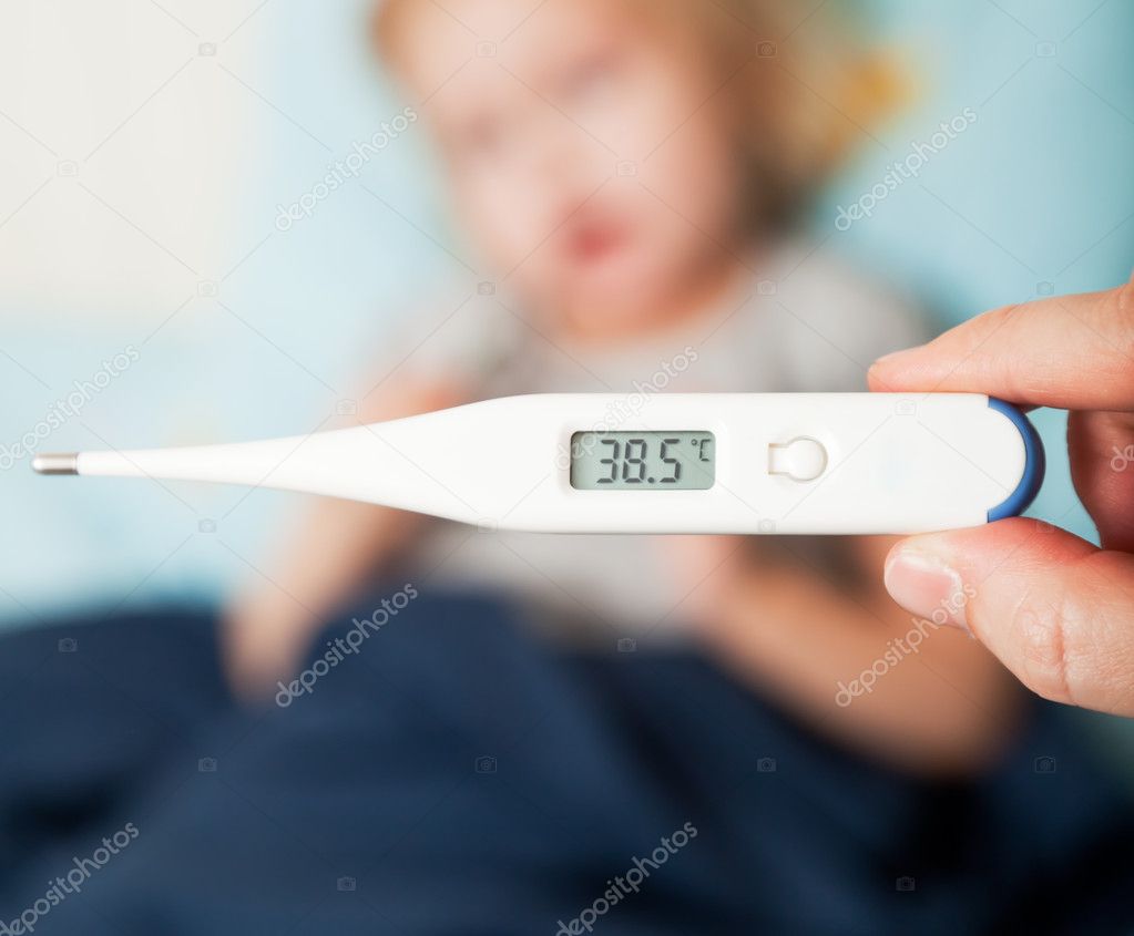 A mother measures the temperature of her daughter