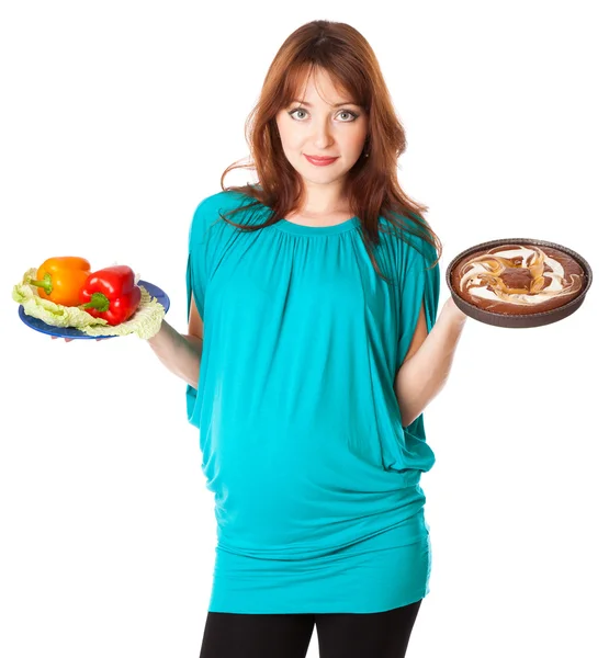A pregnant smiling woman is holding food in her hands — Stock Photo, Image