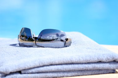 Sunglasses on towel clipart