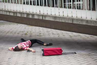 Unconscious woman on asphalt road clipart