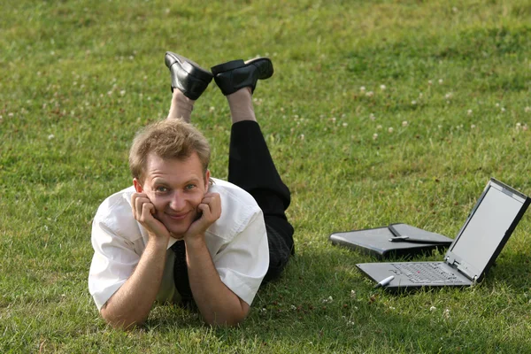 Businessman on the grass — Stock Photo, Image