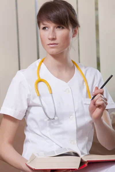 Female doctor with book — Stock Photo, Image