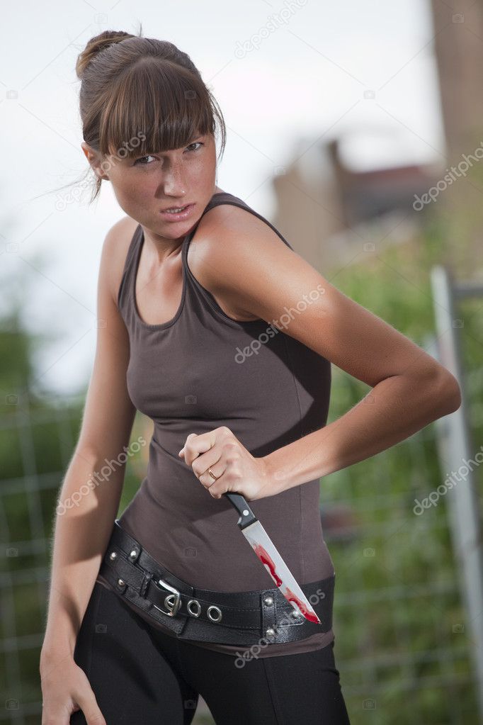 Aggressive woman with bloody knife
