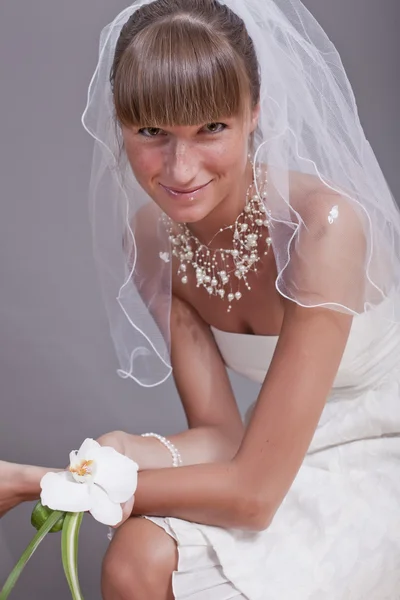 Happy bride with flower — Stockfoto