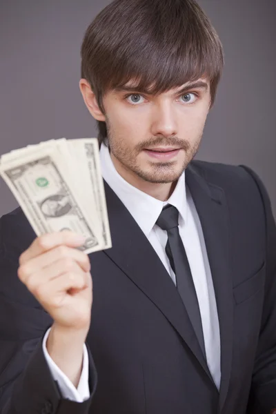 Бизнесмен с долларами в руке — стоковое фото