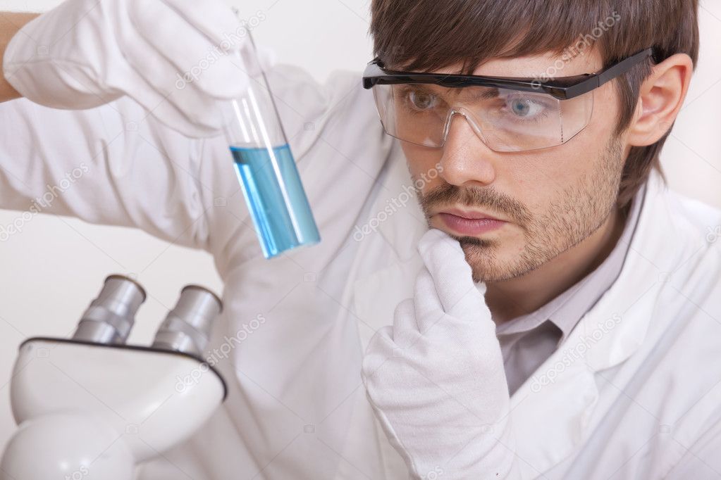 Researcher with blue liquid tube