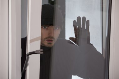Burglar looking into the window clipart