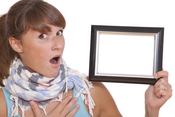Shocked woman with empty photo frame — Stock Photo, Image