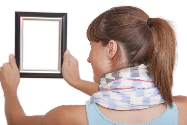Frau hängt Fotorahmen auf — Stockfoto
