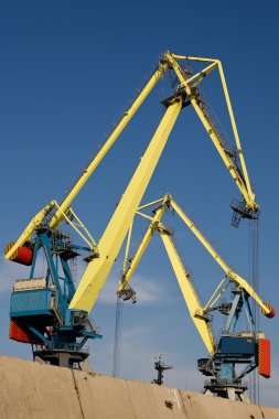 Two big port cranes working clipart