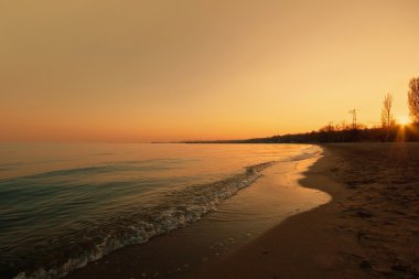 Golden sunset at the seaside clipart