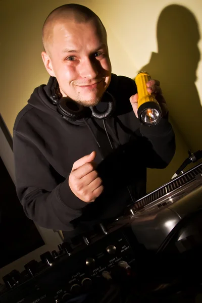DJ mit Taschenlampe an den Plattentellern — Stockfoto