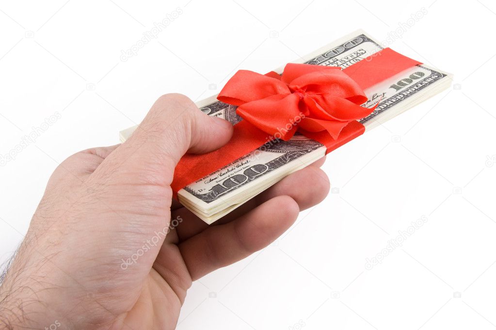 Male hand giving away pack of dollars