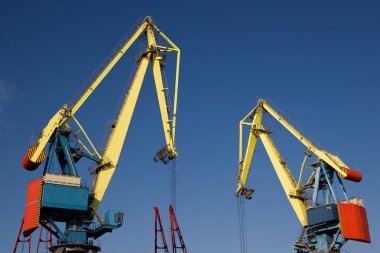 Two industrial level luffing cranes clipart