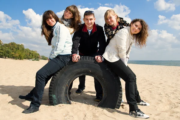 Företaget av tonåriga vänner på stranden — Stockfoto