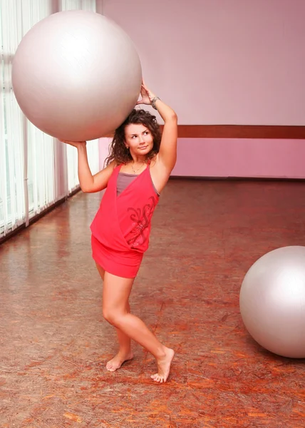 Ung tjej i klänning med fitness boll — Stockfoto