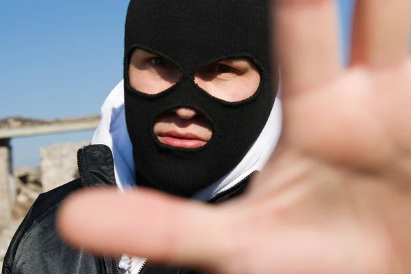Criminal holding his hand in stop gesture — Stock Photo, Image