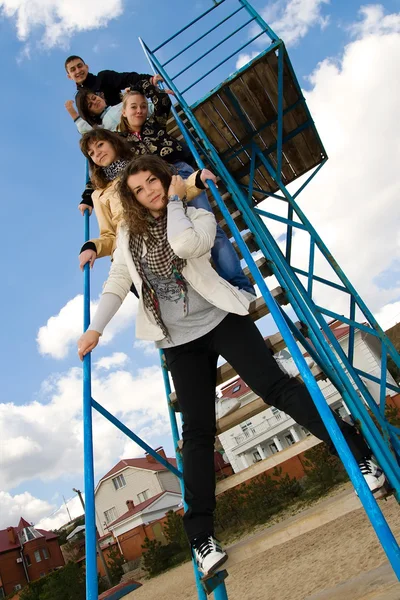 Group of five young on the stairs — Stock Photo, Image