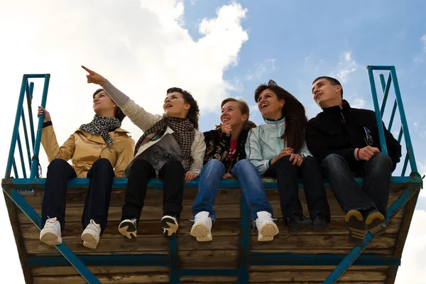 Företag av fem unga sitter tillsammans — Stockfoto