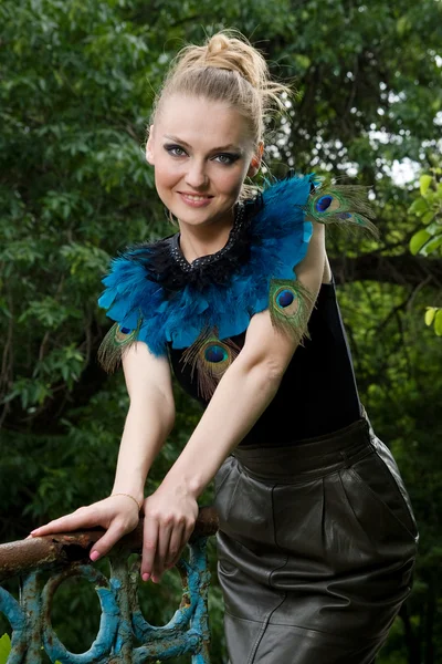Portrait of girl in blouse with peacock feathers — Stock Photo, Image