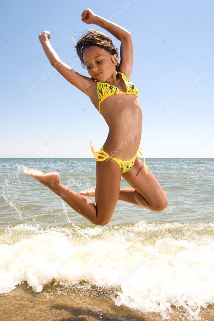 Little girl jumping at the seaside