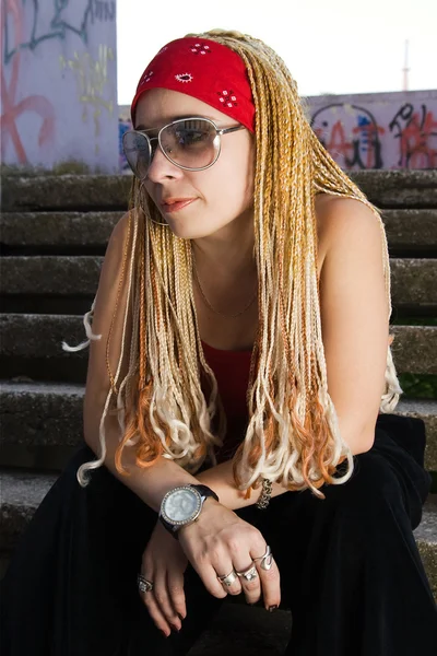 Rapper dívka pózuje na nastříkané stěny — Stock fotografie