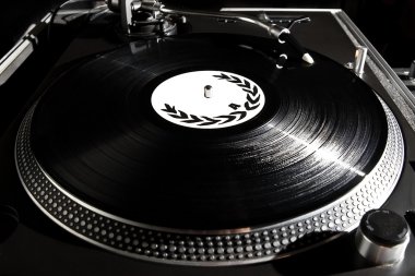 Turntable playing vinyl audio record clipart