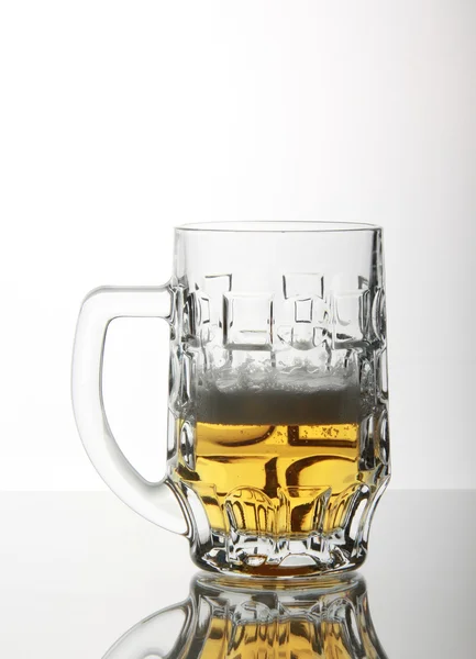 Pub mug on glass table — Stock Photo, Image