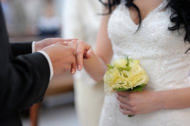 Groom putting ring on clipart