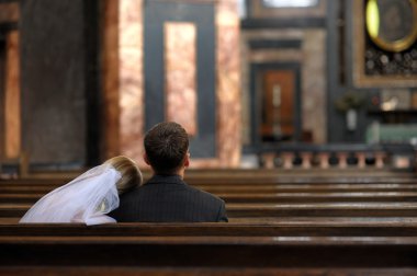 Bride and groom in the church clipart