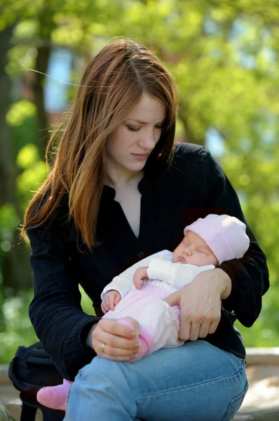 Young mother holding newborn baby — Stock Photo, Image