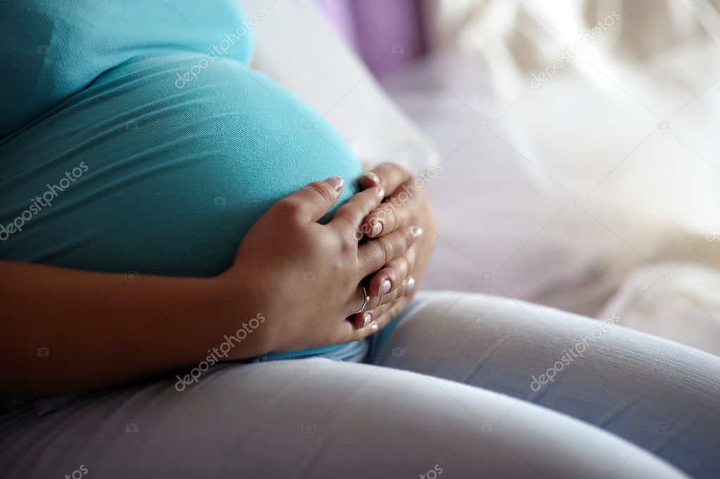 Young mother's pregnant belly