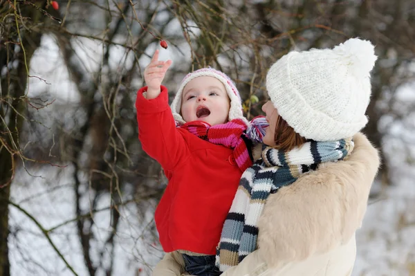 Little winter baby girl and her young mother — Stock Photo, Image