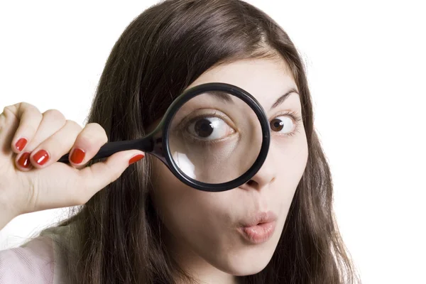 Girl looking through the magnifying glas — Stock Photo, Image