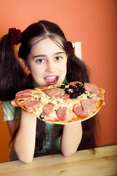 Young girl eat big pizza Stock Picture