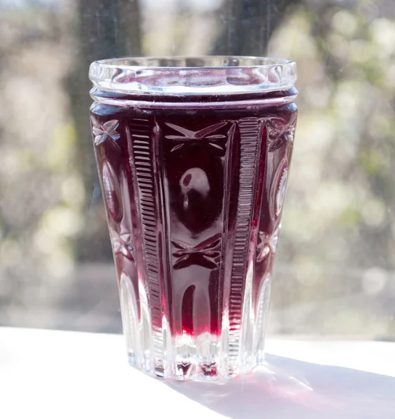 Crystal glass with a fruit drink — Stock Photo, Image
