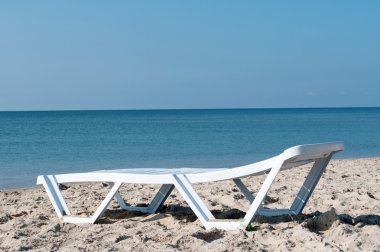 Lounger on the background of the sea clipart