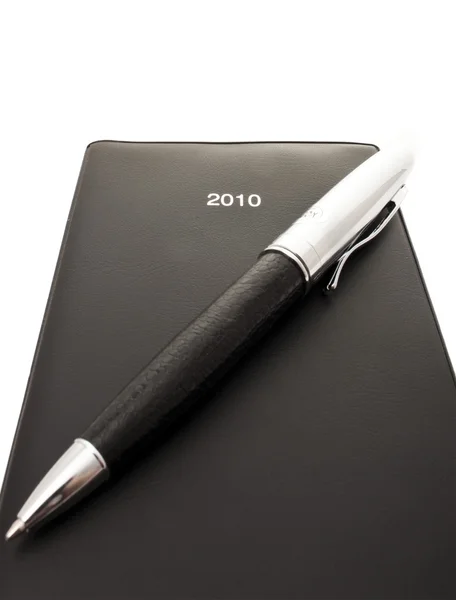 Черный блокнот и ручка — стоковое фото