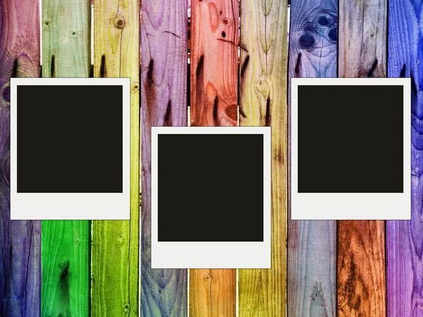 Colorful wooden fence with three blank photos — Stock Photo, Image