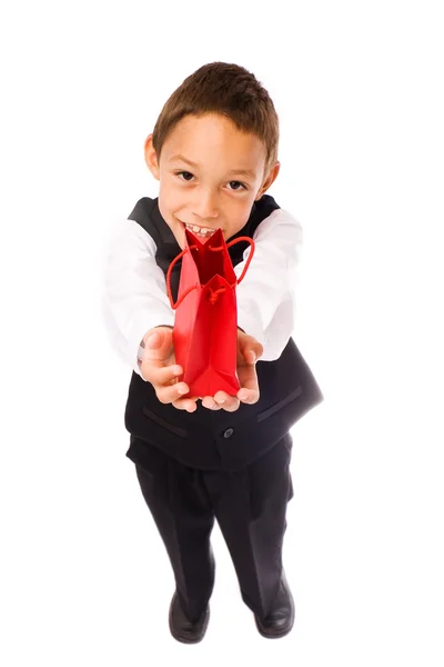 Chlapec hospodářství červená taška — Stock fotografie