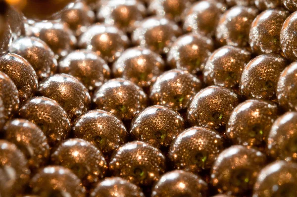 Shiny gold beads background — Stock Photo, Image