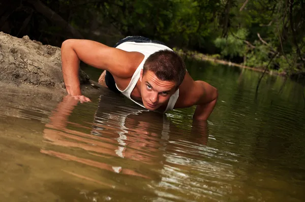 stock image Man doing push-ups on the beach