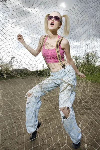 Fashion model behind net webbing — Stock Photo, Image
