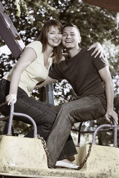 Smiling couple on the carousel — Stock Photo, Image