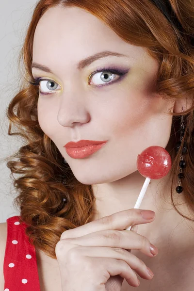 Woman holding candy — Stock Photo, Image