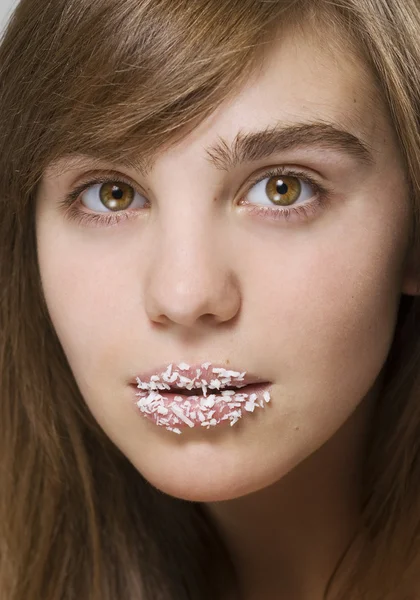 Girl with a coconut shaving on lips — Stock Photo, Image